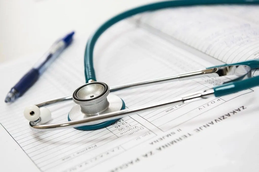 Medical coder looking up CPT, HCPCS, modifier and denial codes in a billing code reference library
