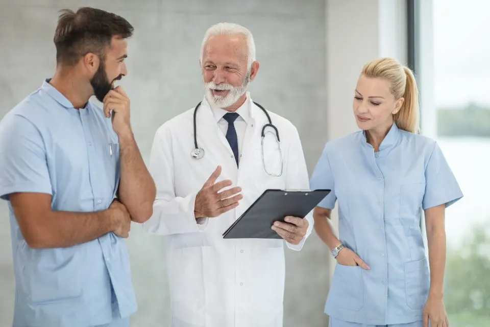 Clinical team reviewing a claim on a clipboard